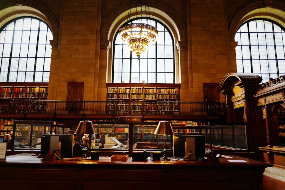 a library filled with lots of books and a chandelier