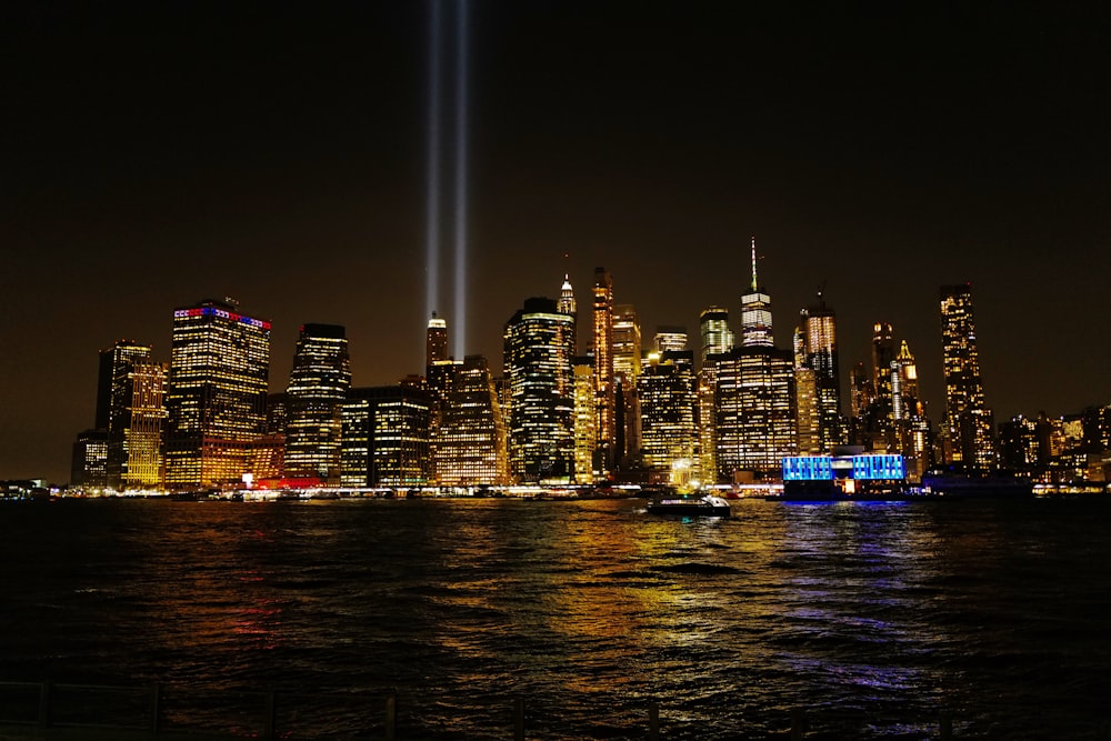 lighted buildings across body of water