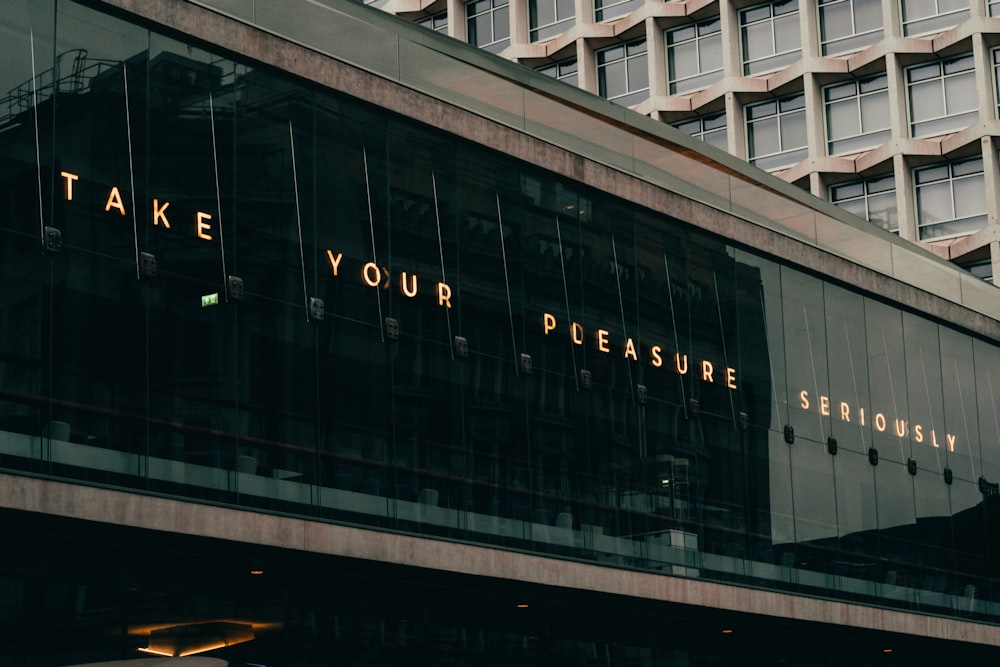 a building with a sign that says take your pleasure seriously