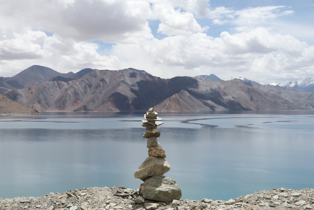 gray balance stones near body of water during daytime