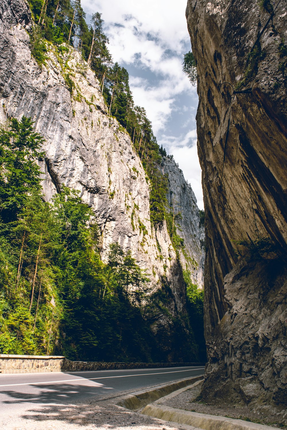 a view of a narrow road between two mountains