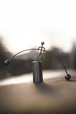 silver-colored stick man figurine