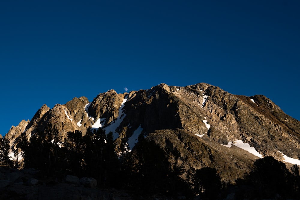 brown and white mountain under blue sky at daytime