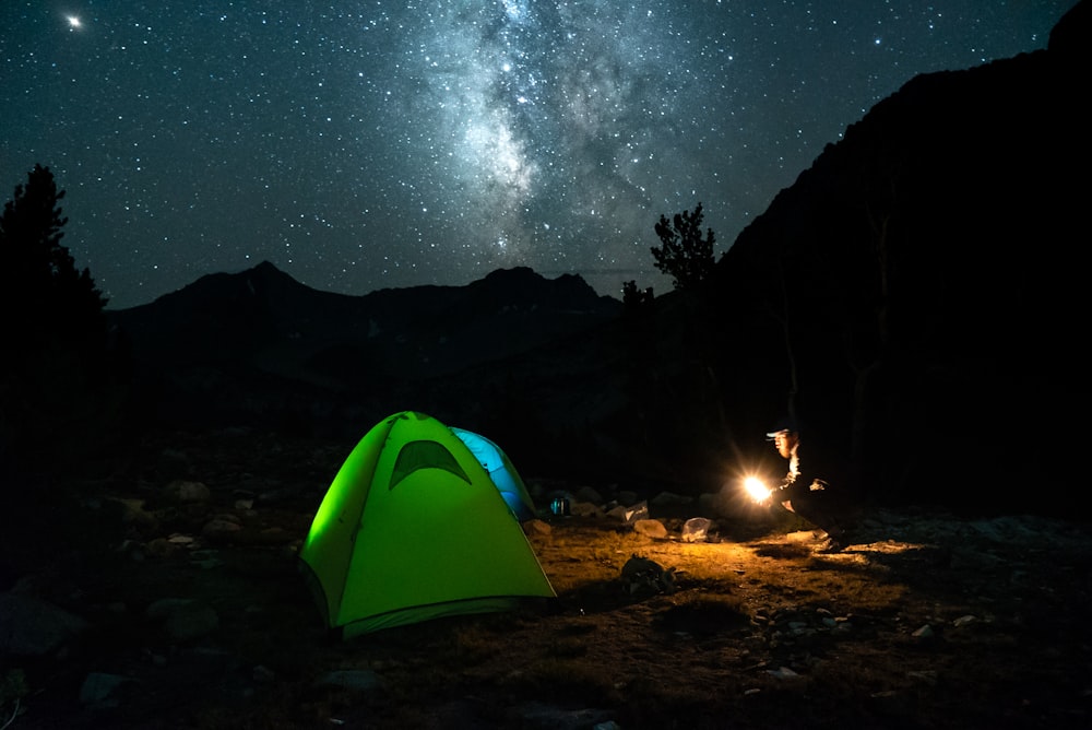 green tent near fire at night