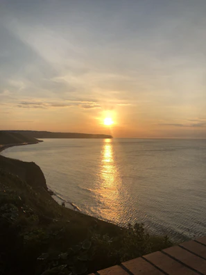 A serene sunset over the Almería coastline with warm golden hues.
