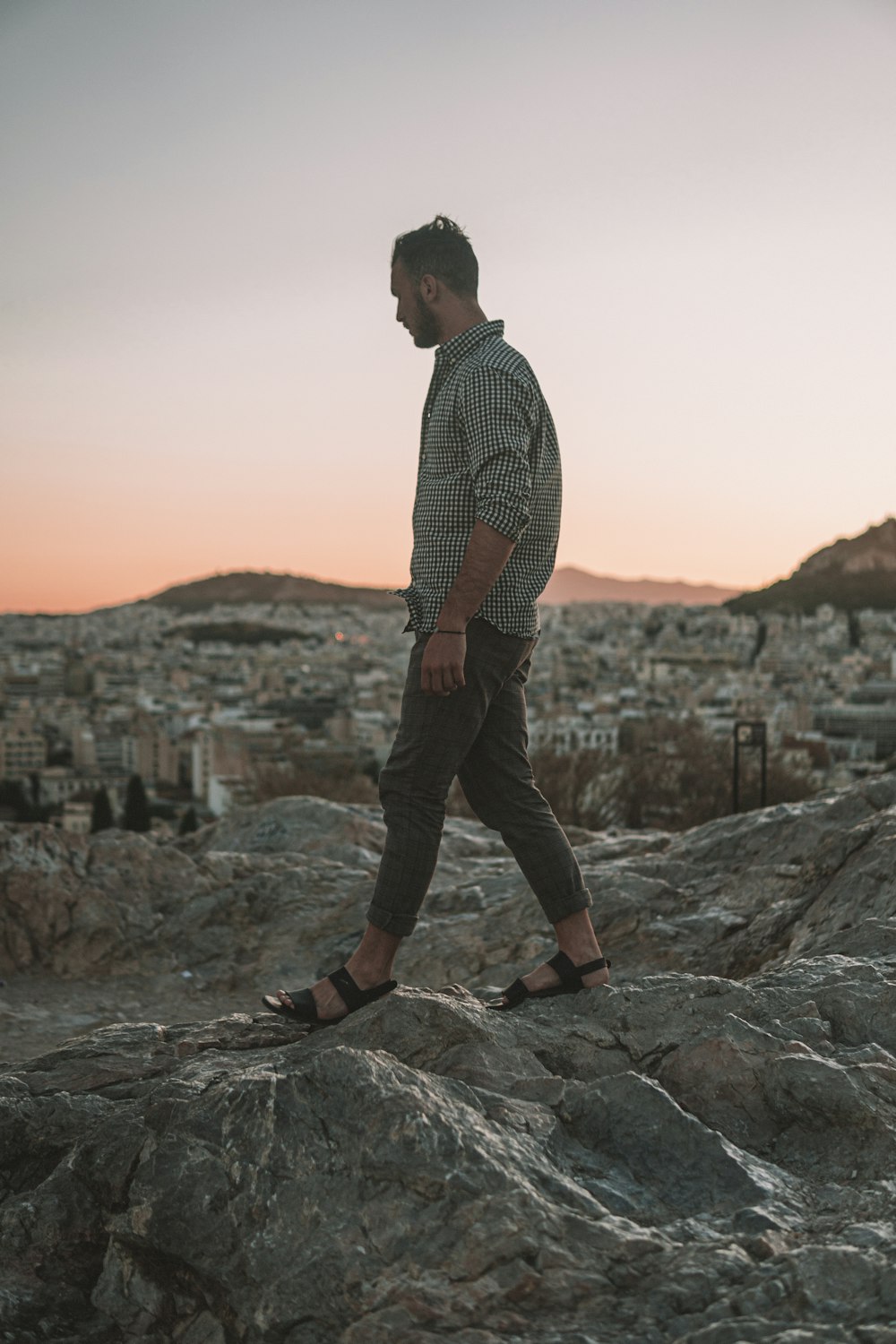 man walking on the rocky field photography