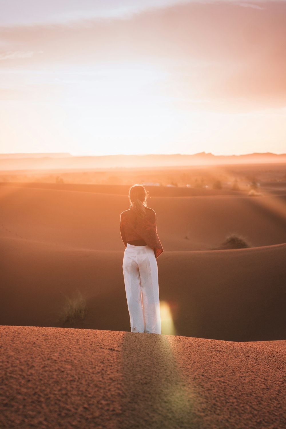 woman standing on the sand field