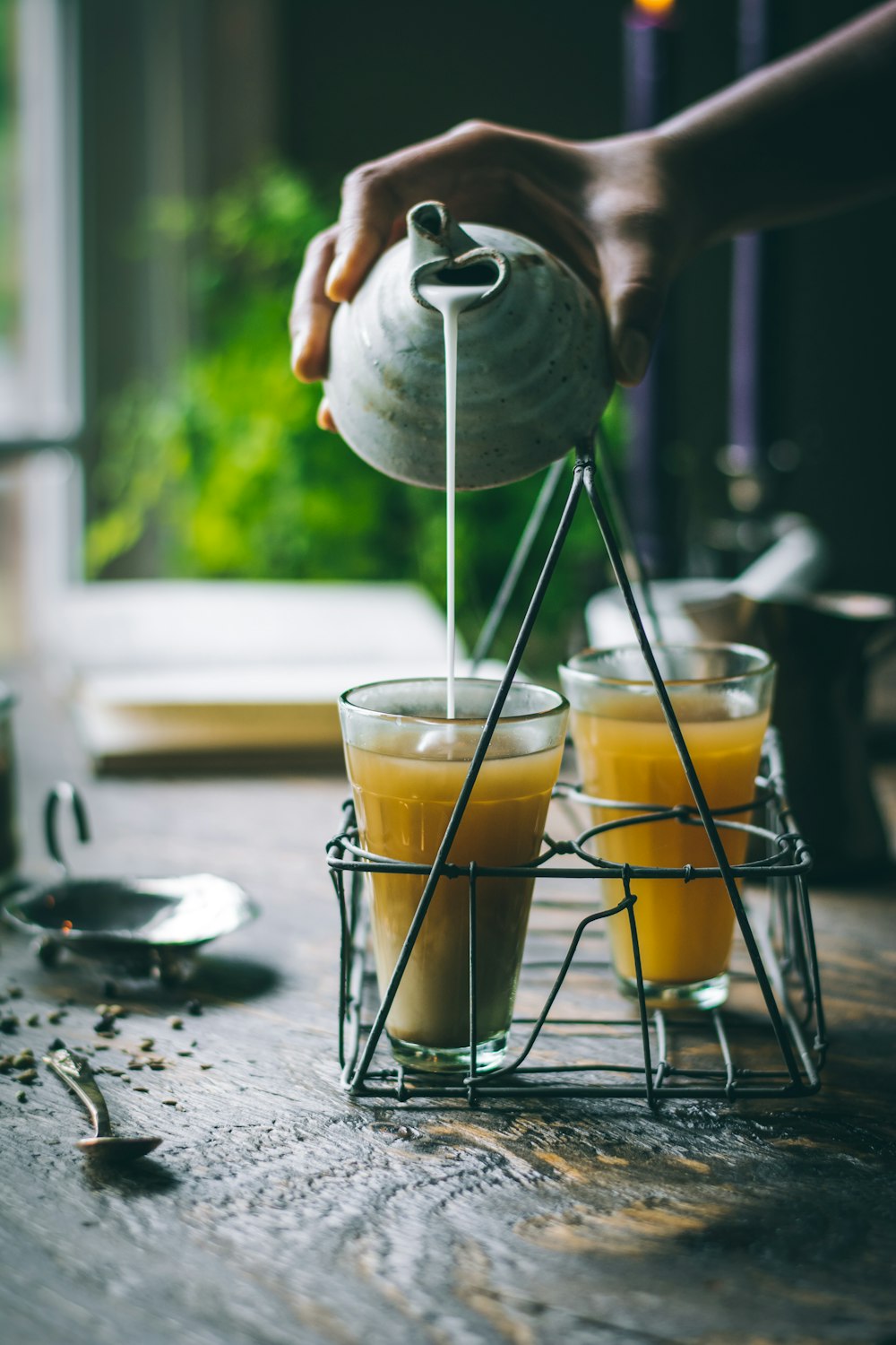 person pouring juice to the glass