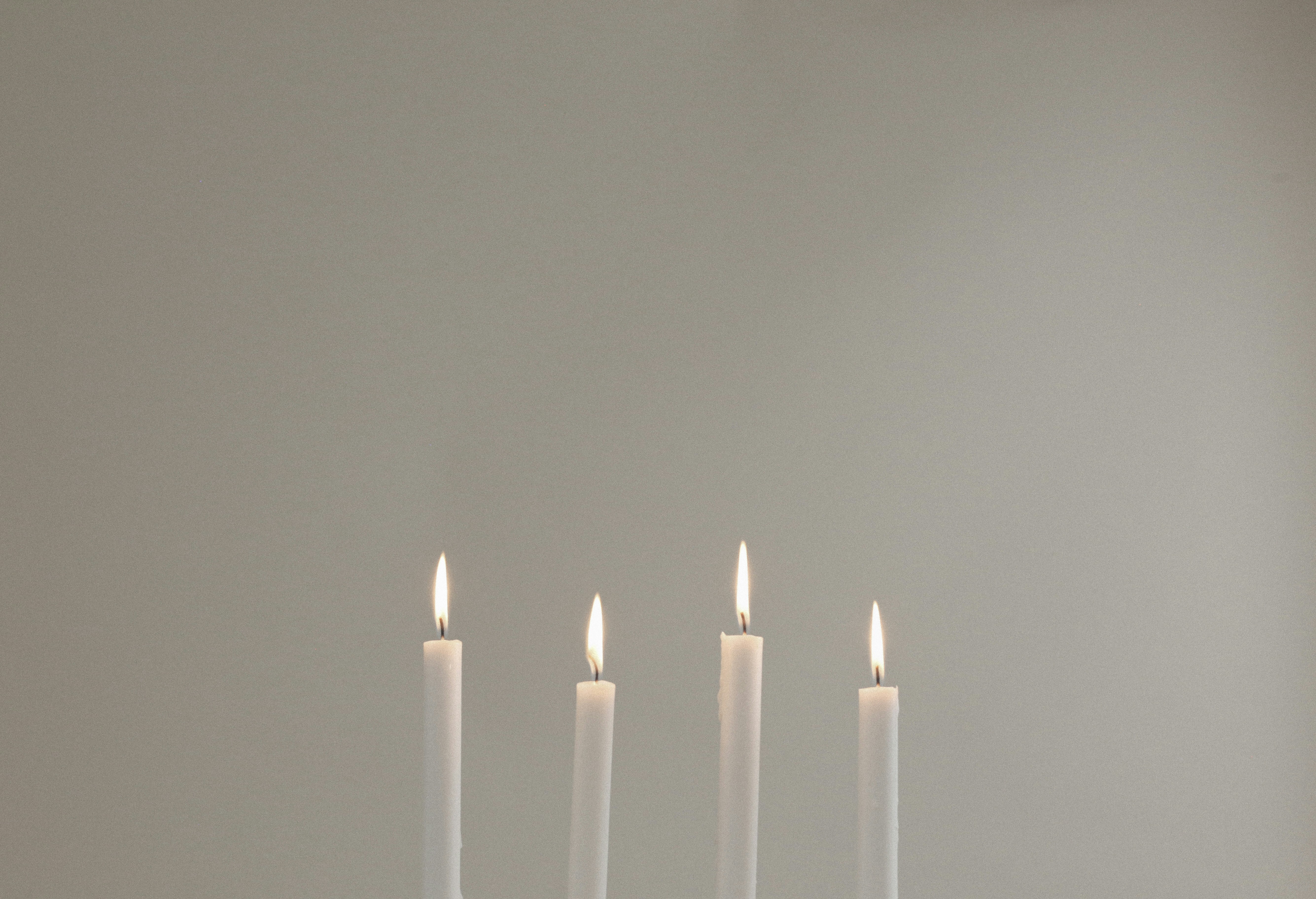 four lighted white candles