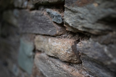 Close-up of textured stone wall with subtle shadows emphasizing materiality.