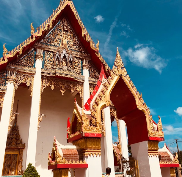 gold and white shrine under blue sky