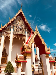 gold and white shrine under blue sky
