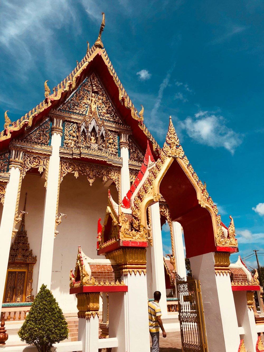 gold and white shrine under blue sky