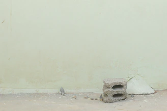 A minimalist stage setup blending with cracked walls and peeling paint in an old building.
