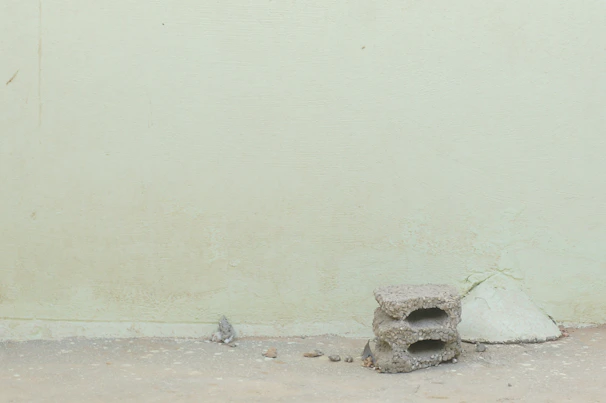 A minimalist stage setup blending with cracked walls and peeling paint in an old building.