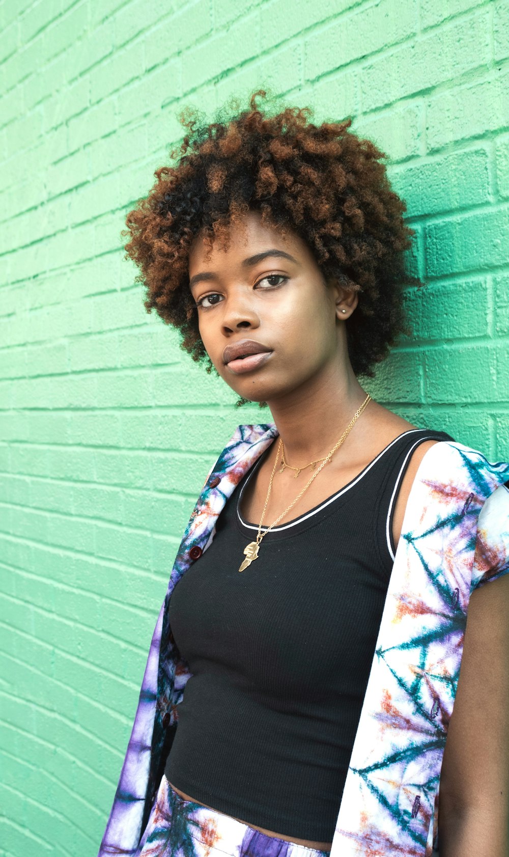 woman leaning against concrete wall