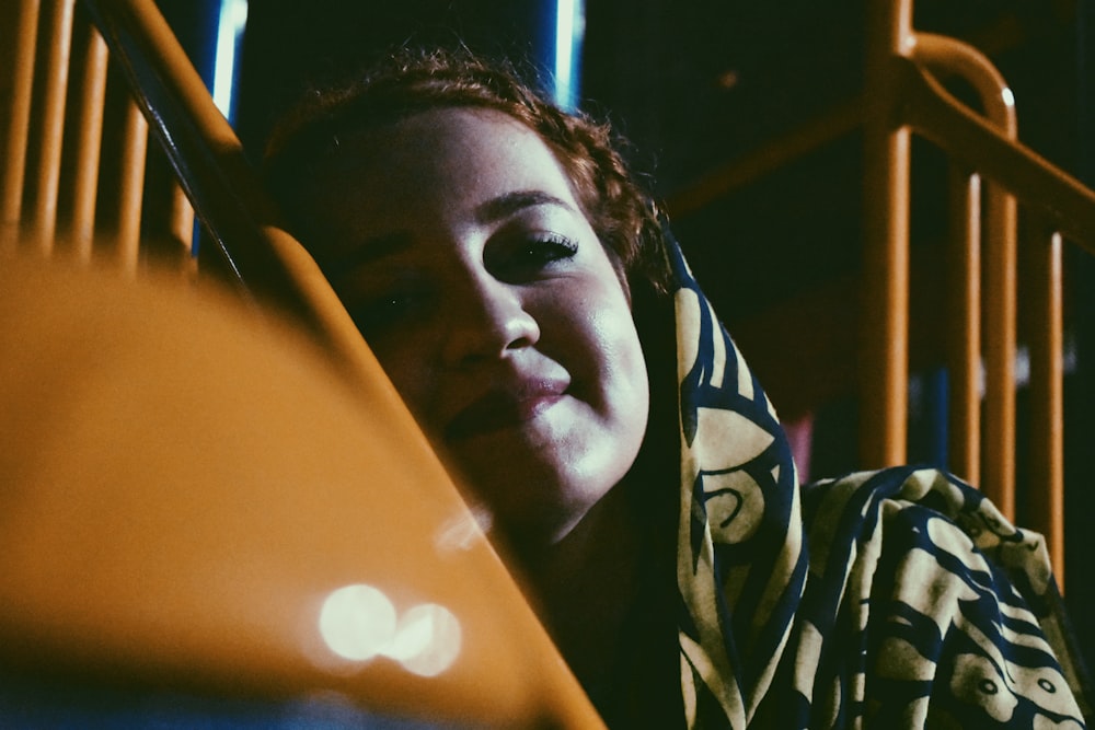 woman leaning on yellow metal railings