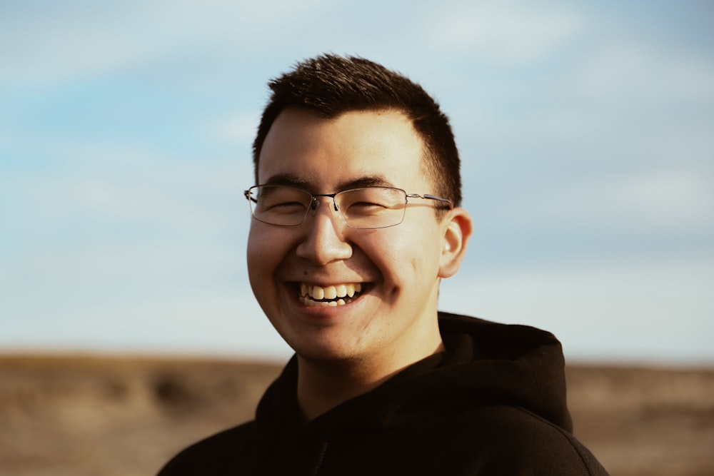 smiling man wearing black pullover hoodie