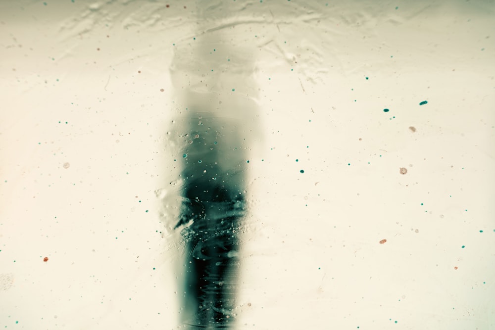 a black and white photo of a person standing in the rain