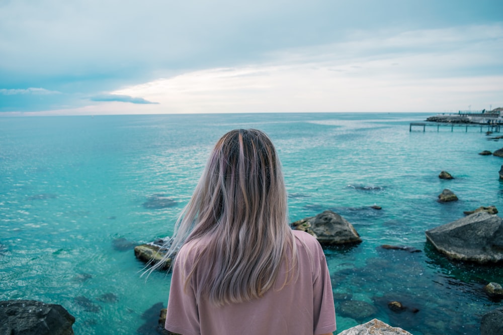 woman standing beside sea