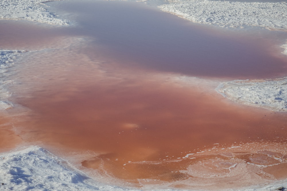 a large body of water surrounded by snow