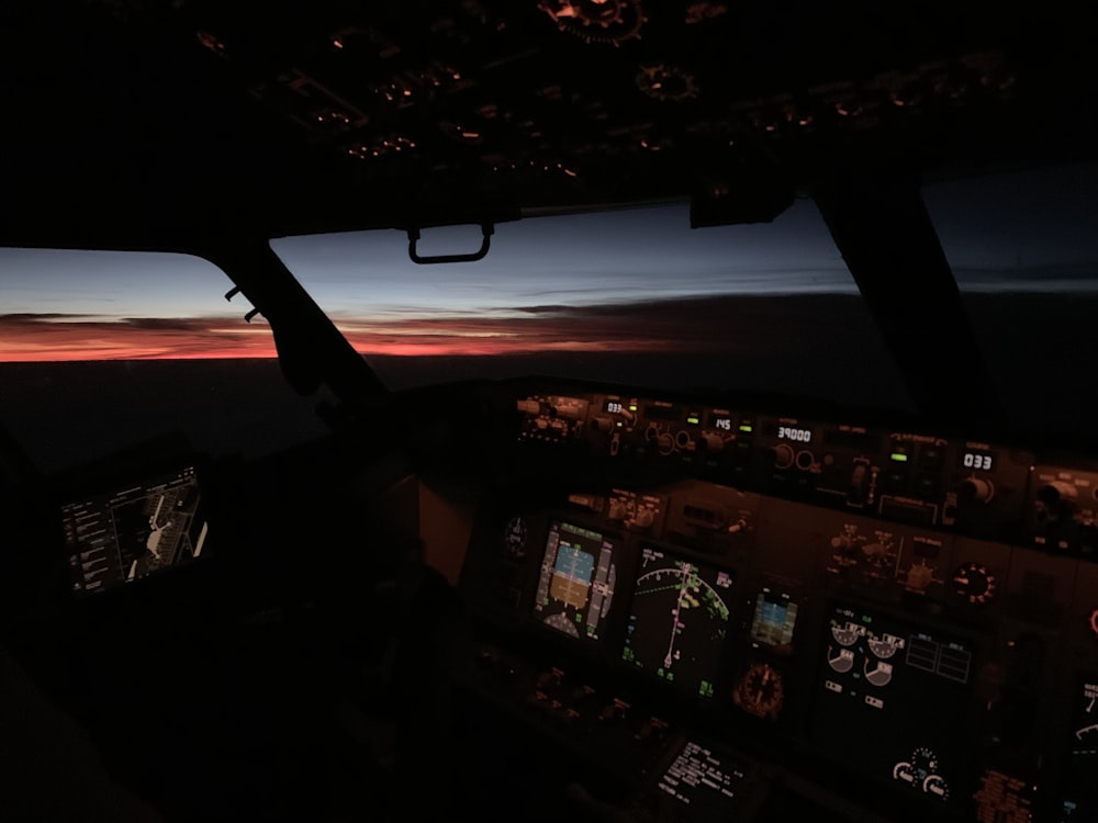 the view from the cockpit of a plane at sunset