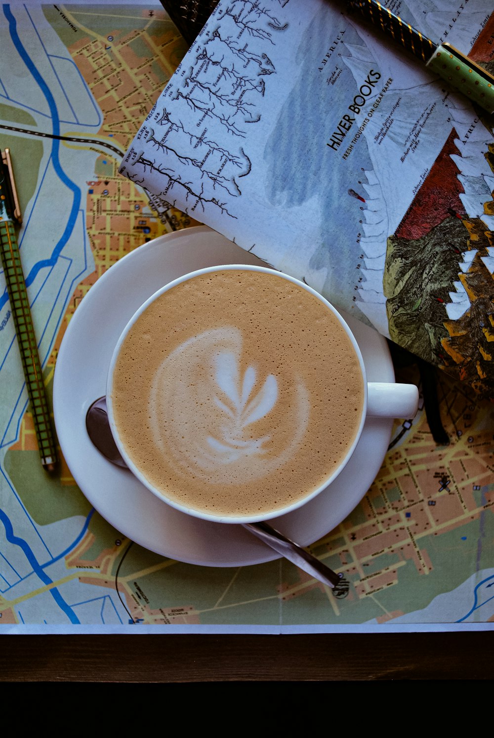 flat lay photography of coffee served on white mug