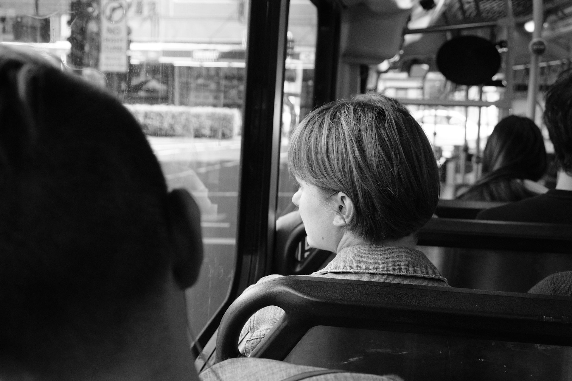 grayscale photography of people near inside vehicle