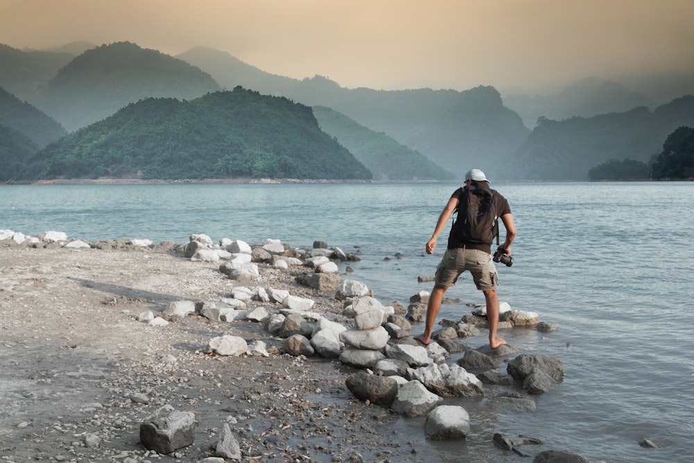 man walking on seashore