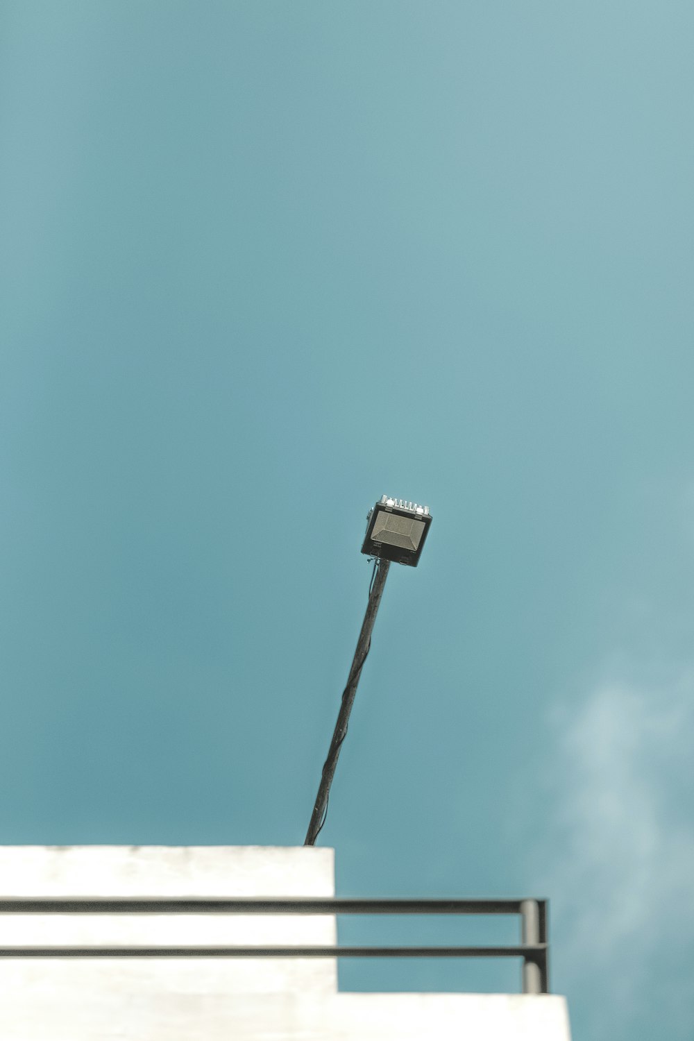 a street light sitting on top of a white building