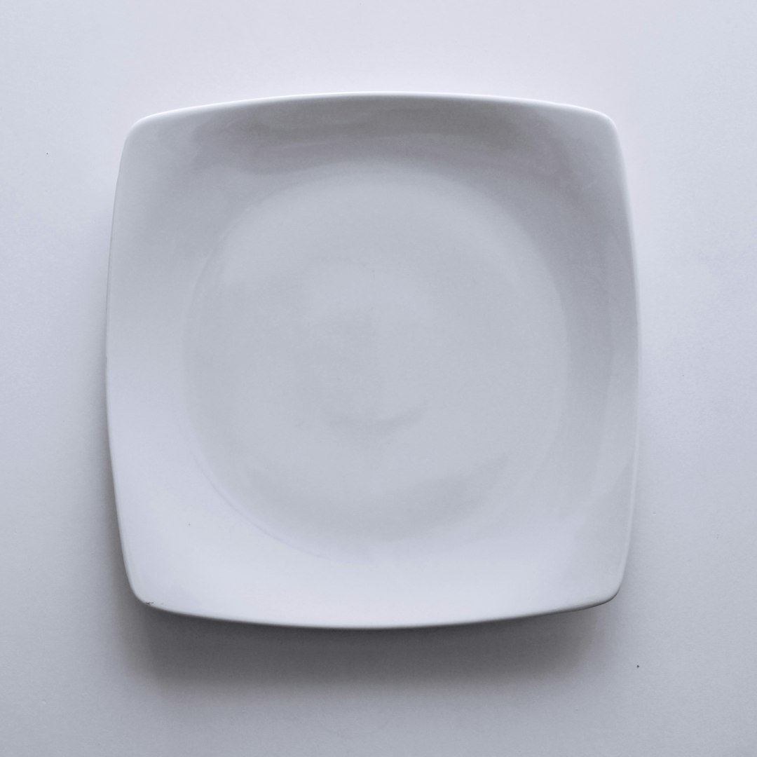  empty ceramic plate on white textile dish
