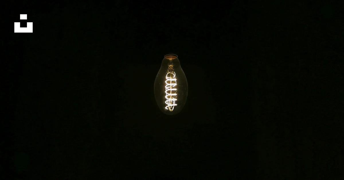 A light bulb is lit up in the dark photo – Free Black Image on Unsplash