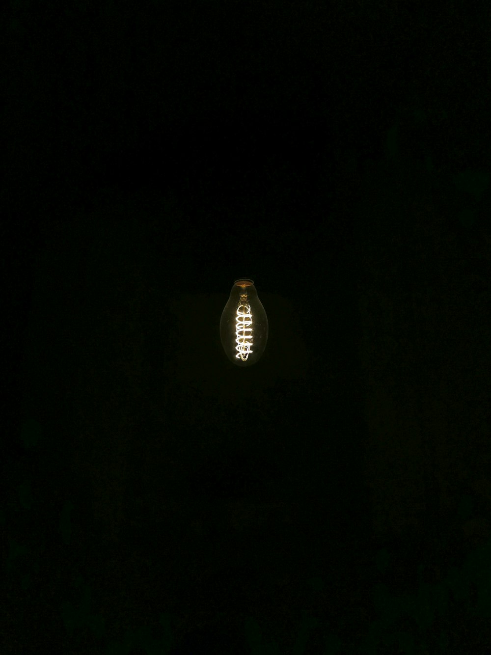 a light bulb is lit up in the dark