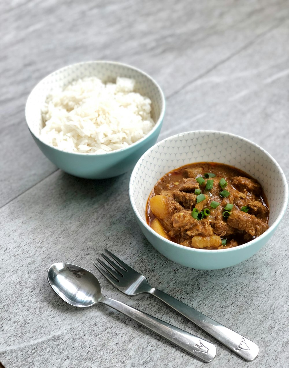 spoon and fork beside two white bowls