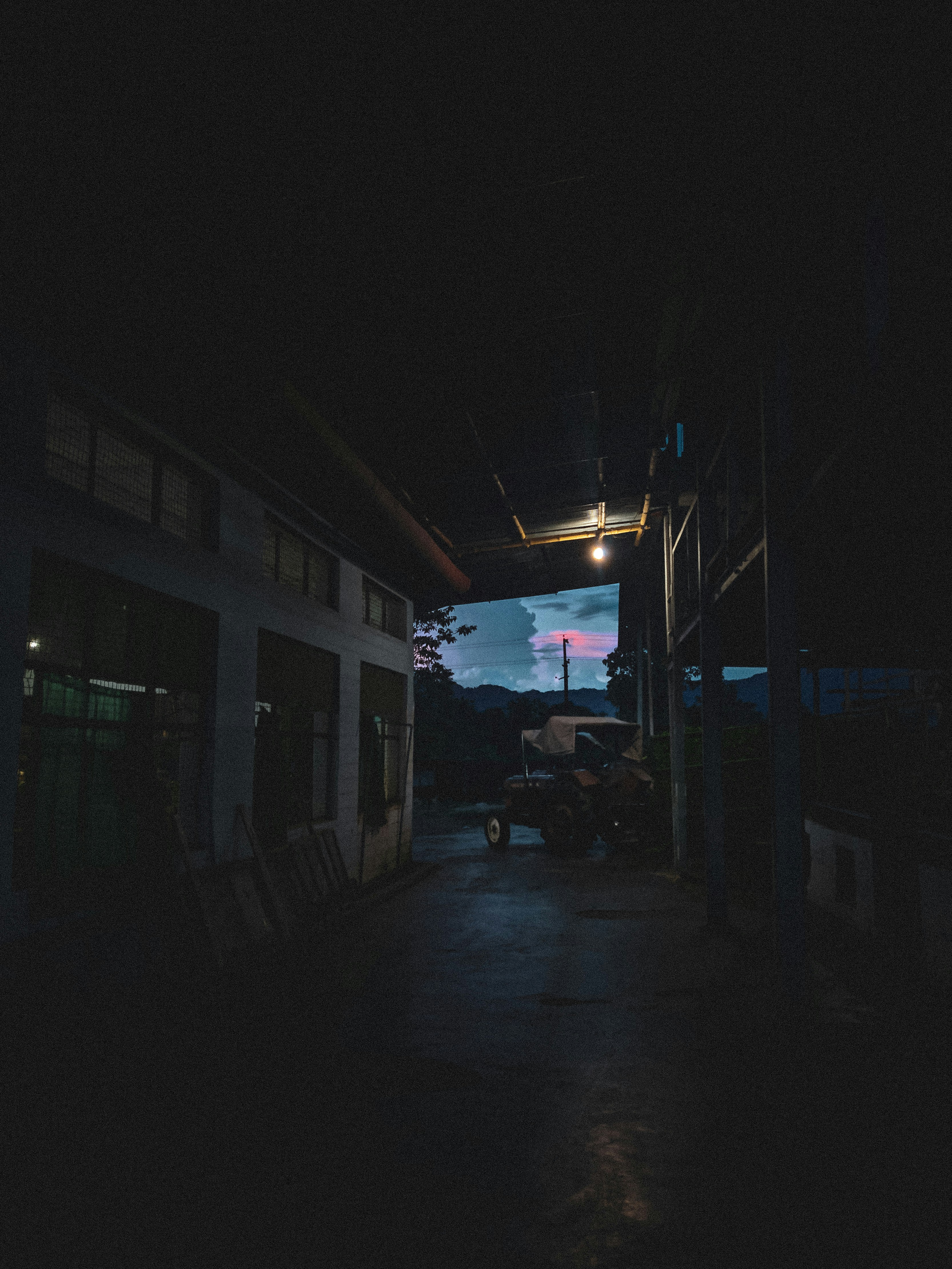 a car is parked in a dark alley