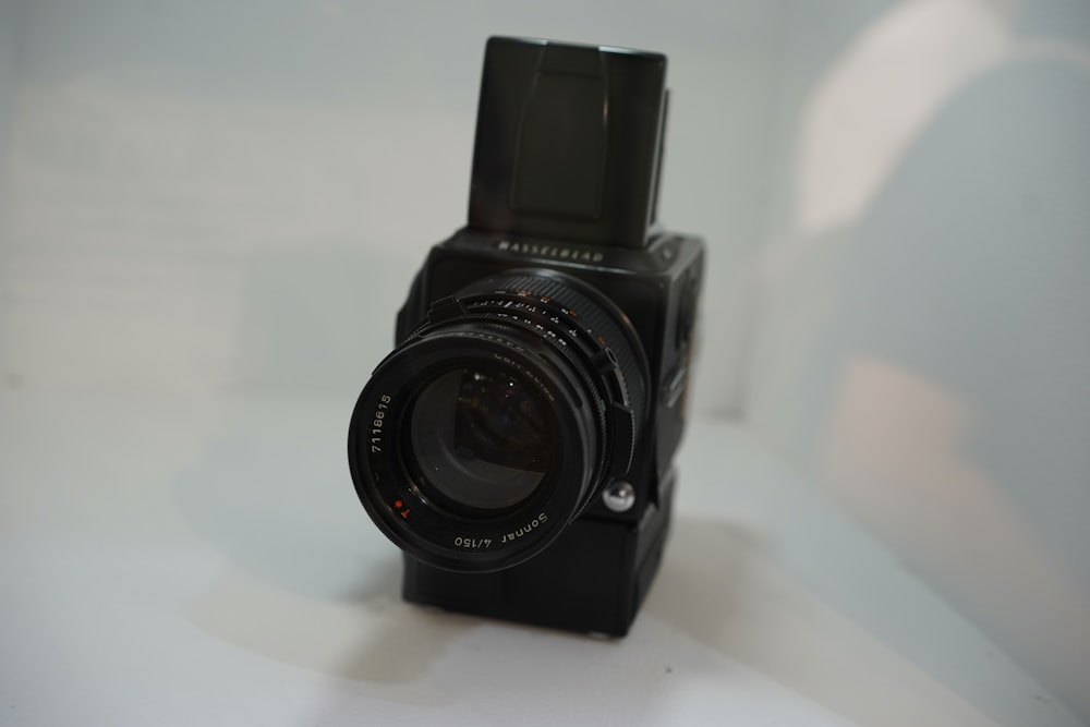 black camera on white surface