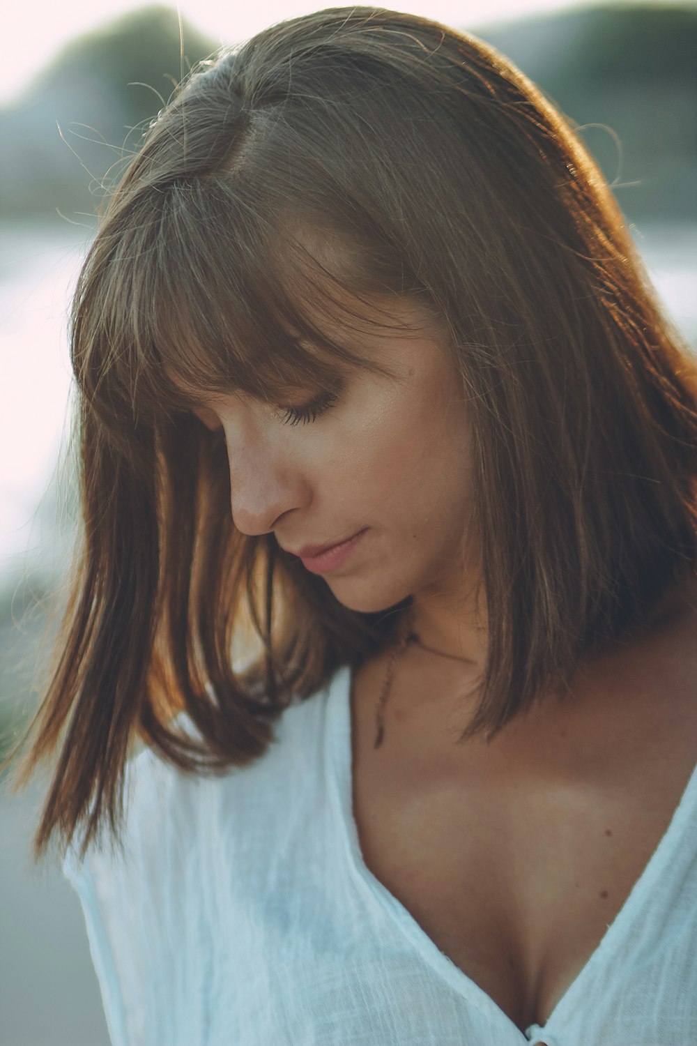 woman in white V-neck top