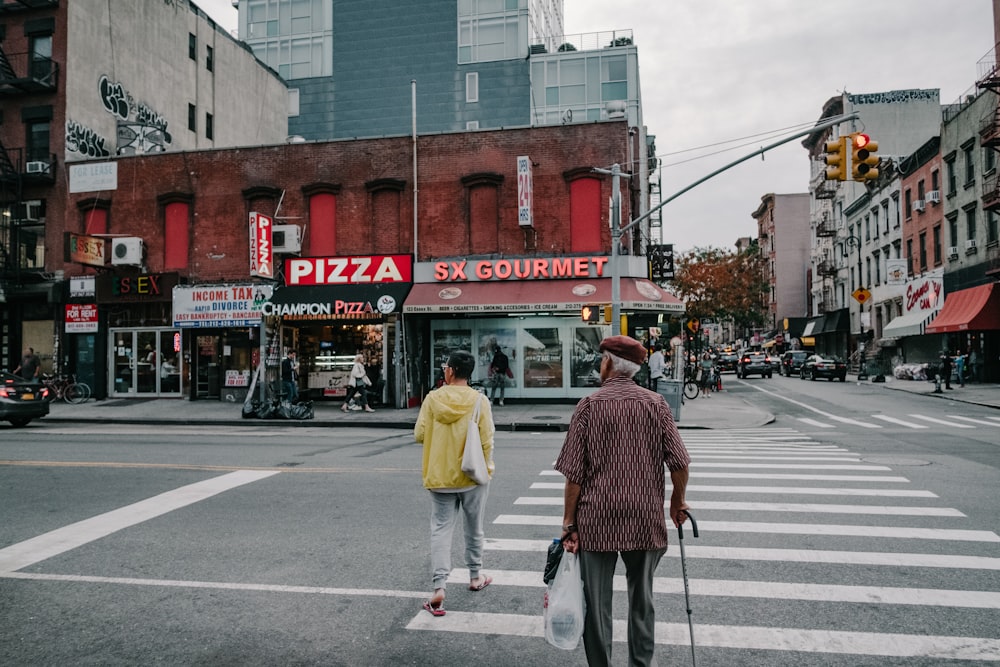 two people crossing pedestrian lane