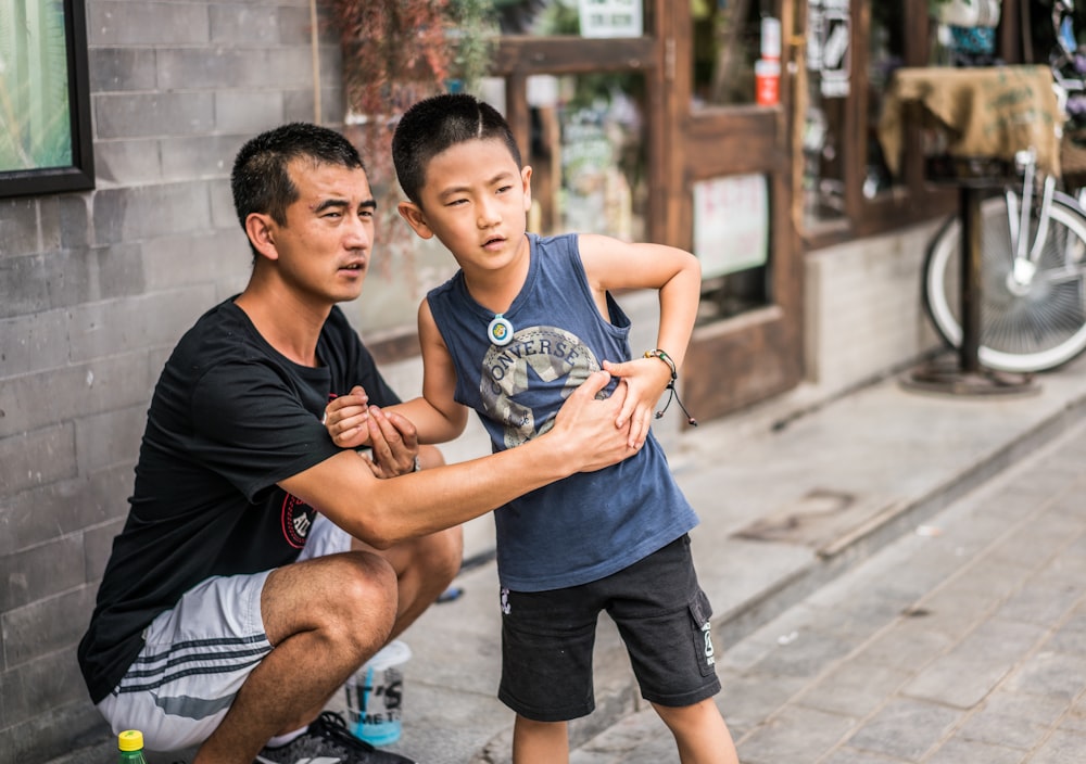 boy wearing black tank top