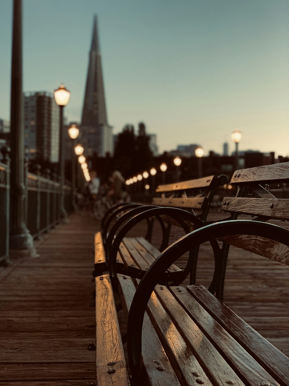 a row of wooden benches sitting next to each other