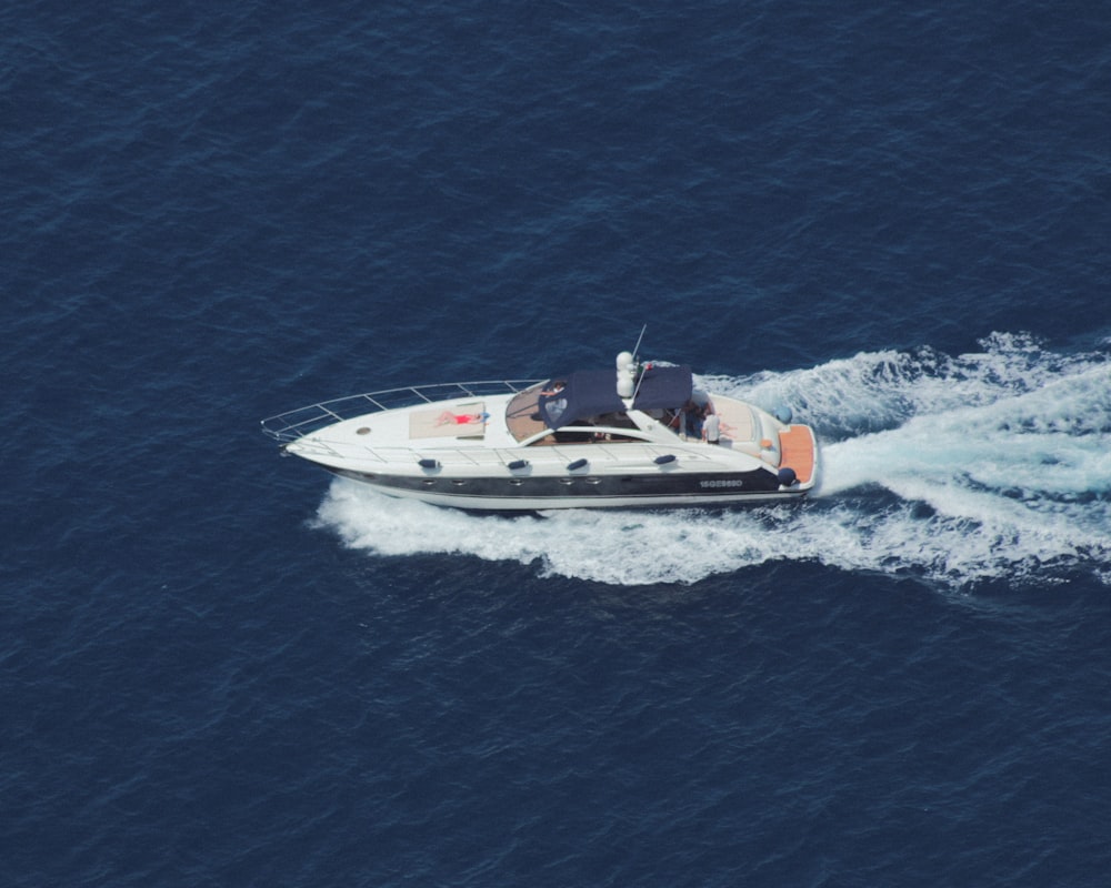 white and black speedboat on sea