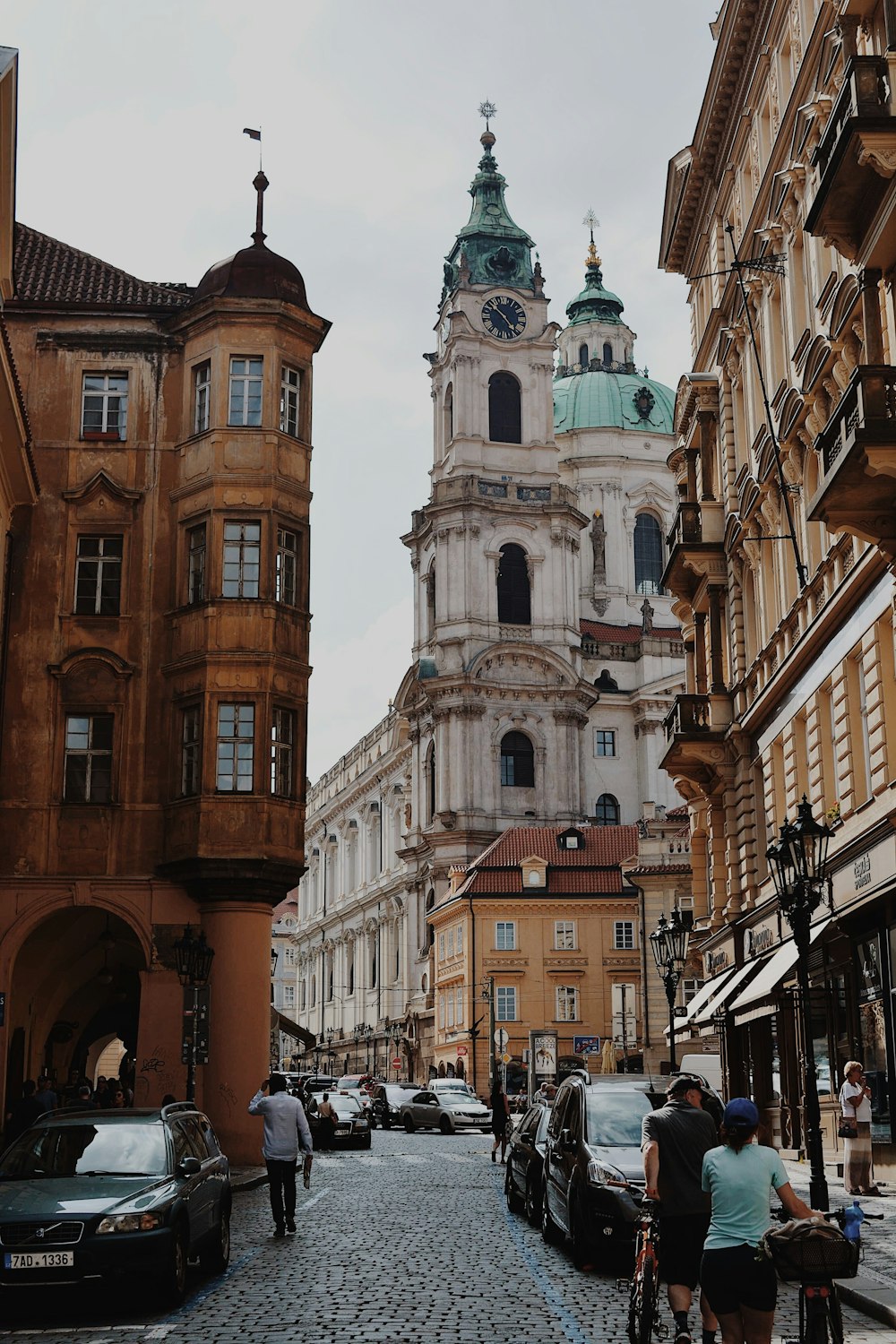 people and cars at the city during day