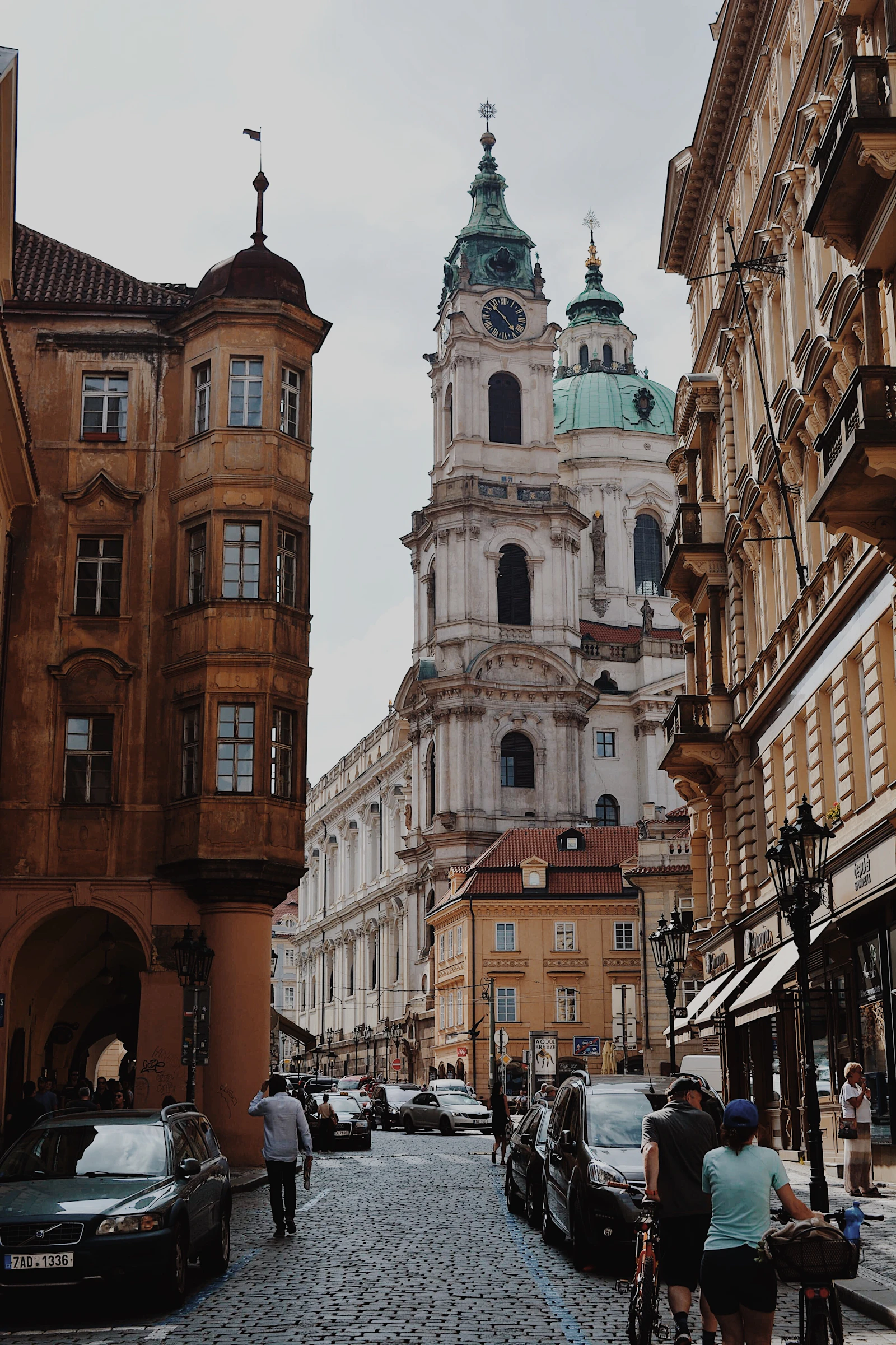 Car moves through evening traffic on a Prague street