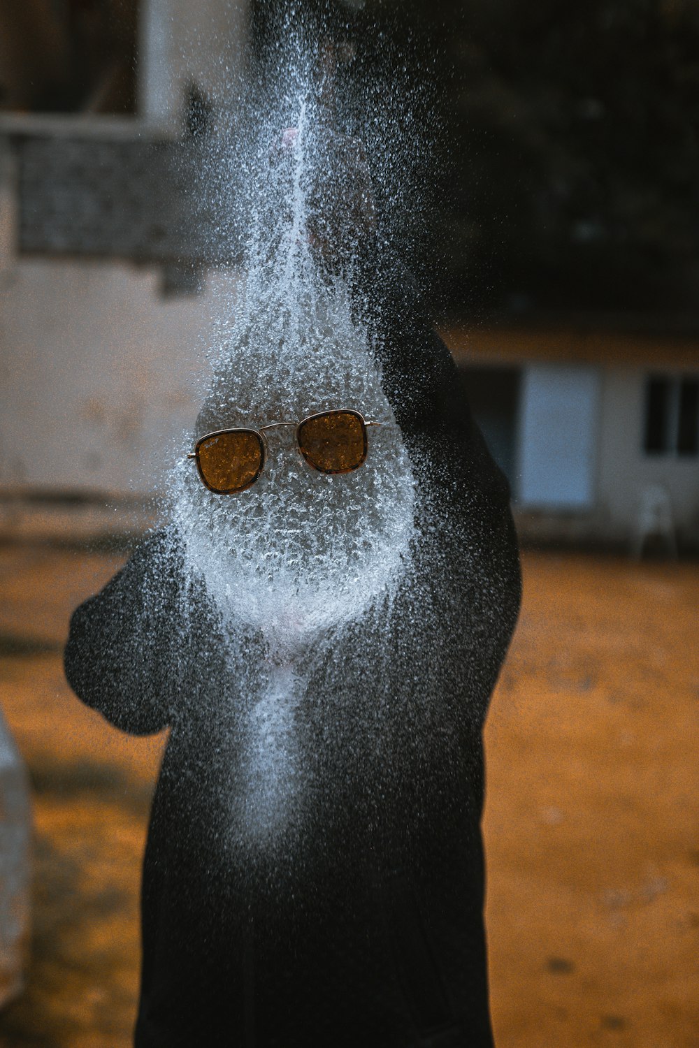 a person standing in front of a fire hydrant covered in snow