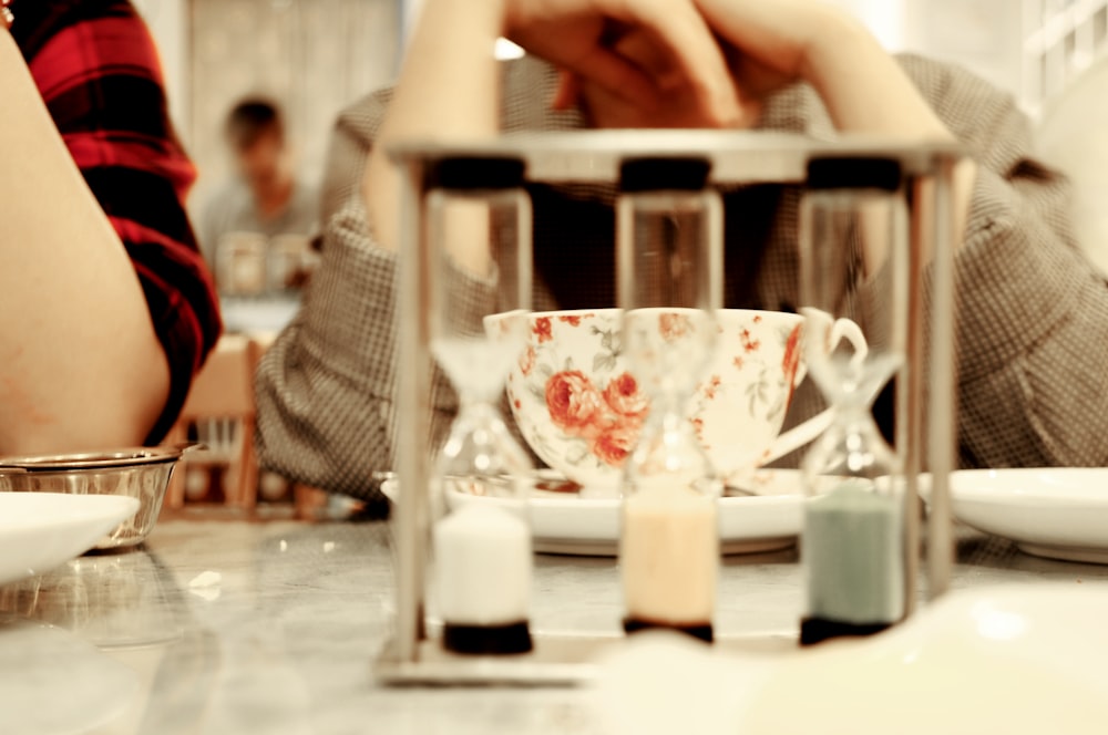 a person sitting at a table with a coffee cup