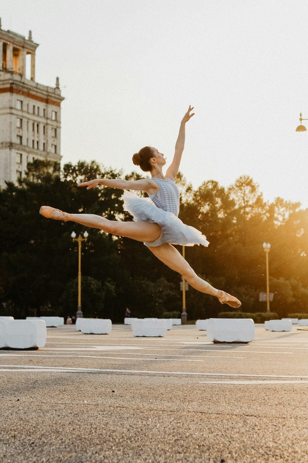 girl wearing gray dress dancing during daytime