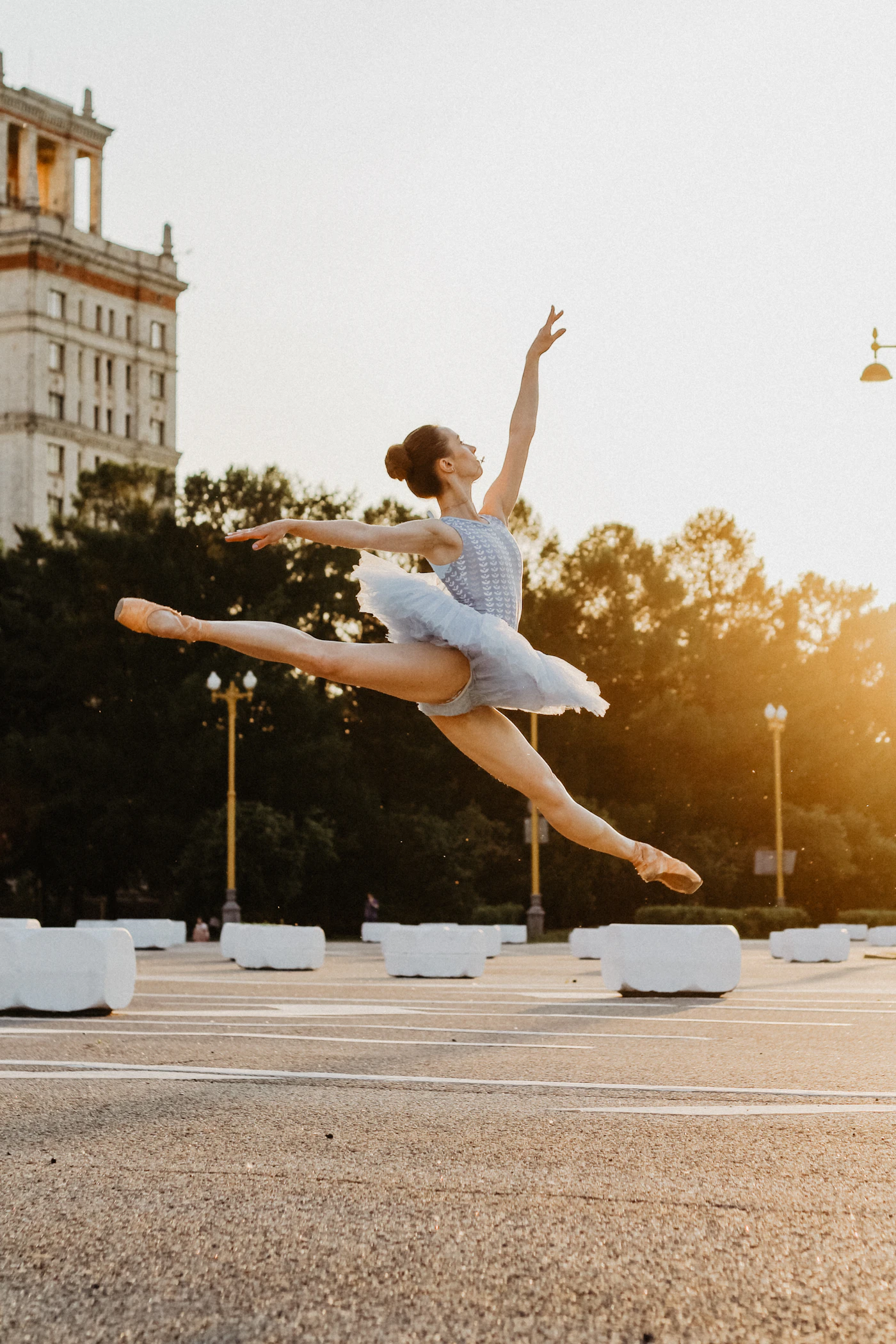 A ballet dancer poised gracefully on pointe in a sunlit studio