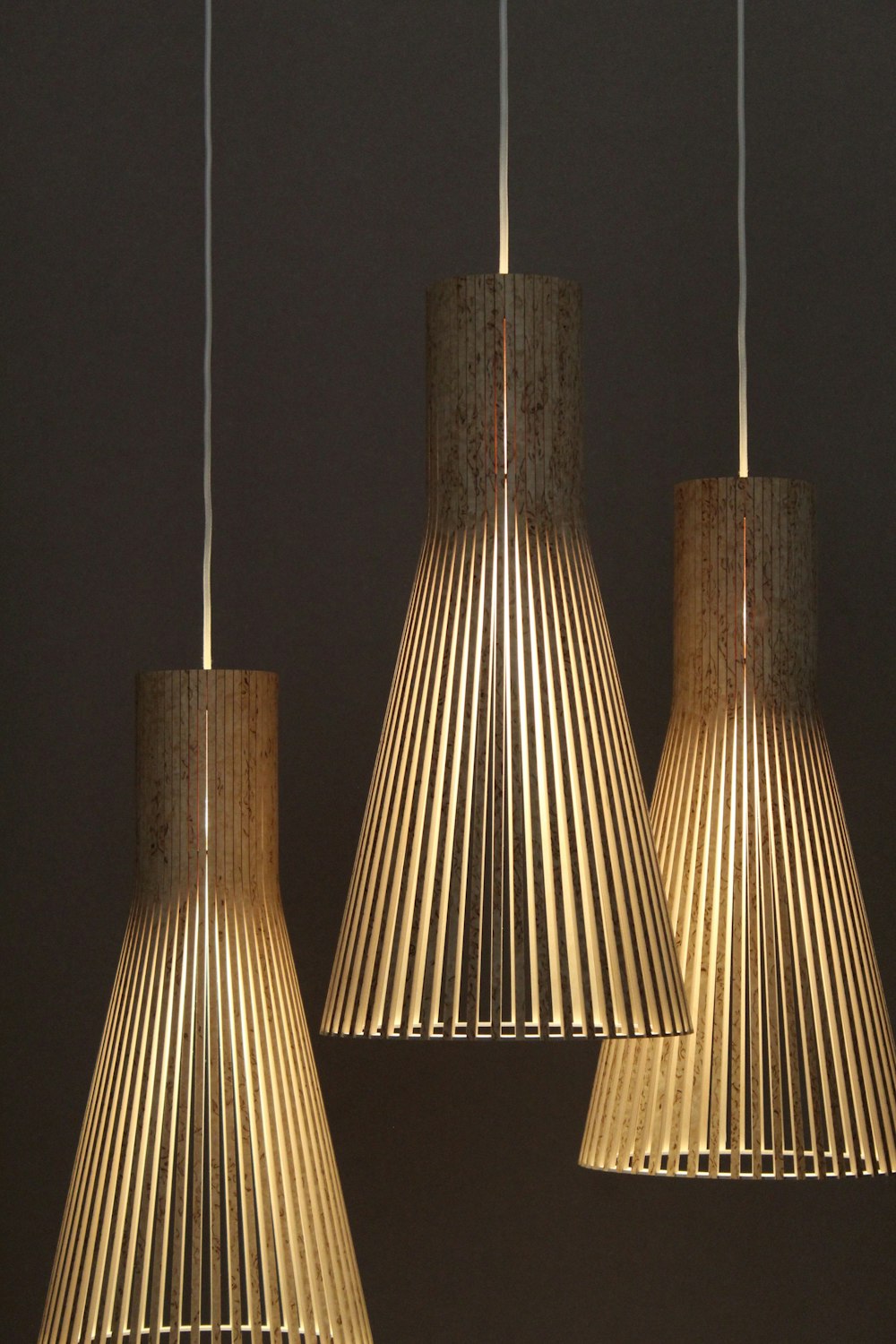 three gold pendant lamps