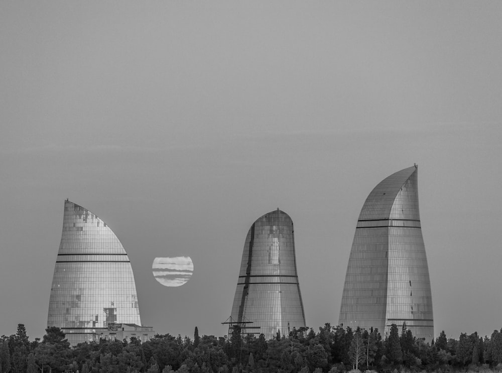 three grey buildings near trees