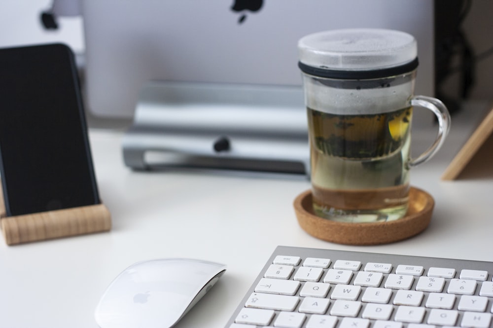 filled mug near keyboard